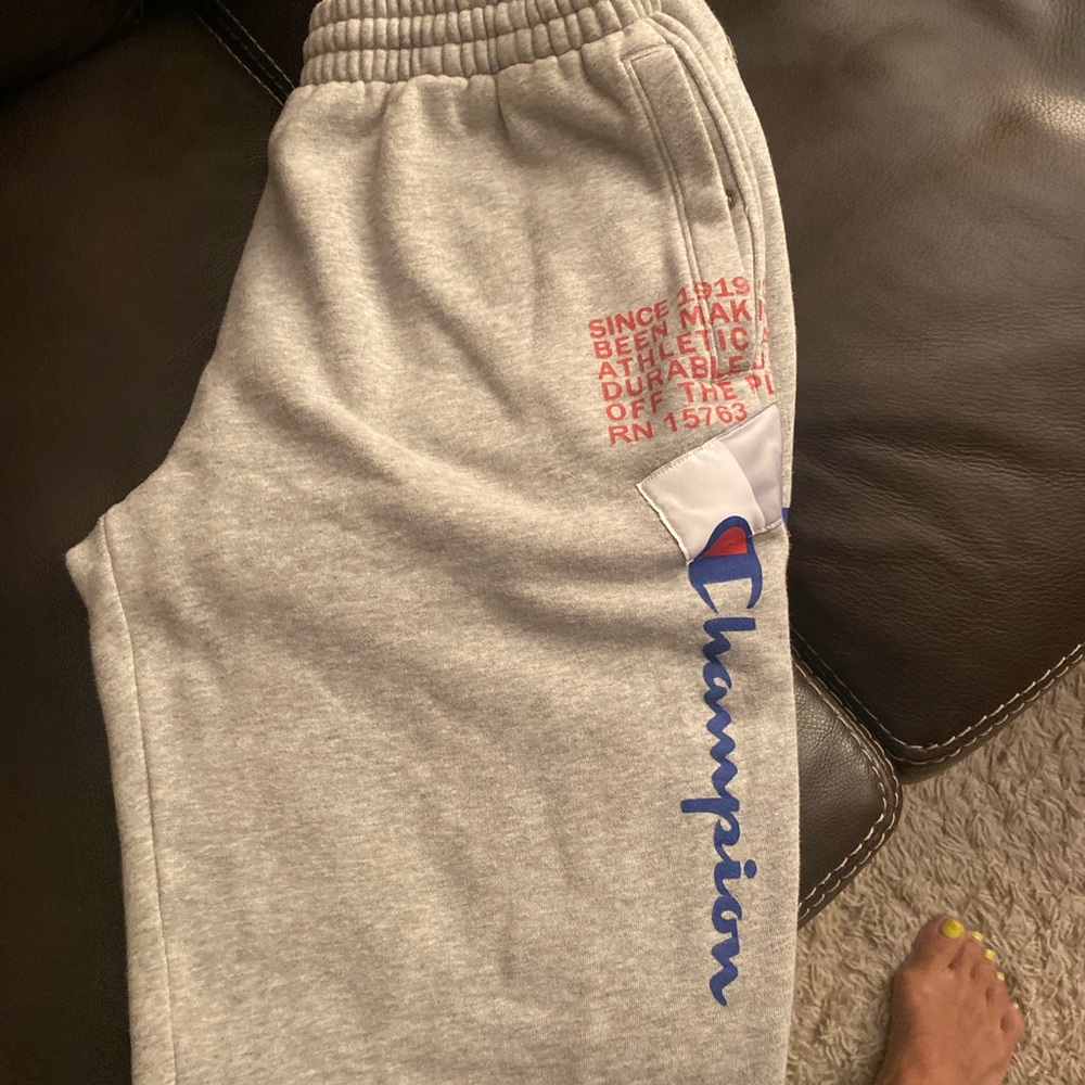 A pair of men’s champion sweatpants size M gray & red & blue champion logo